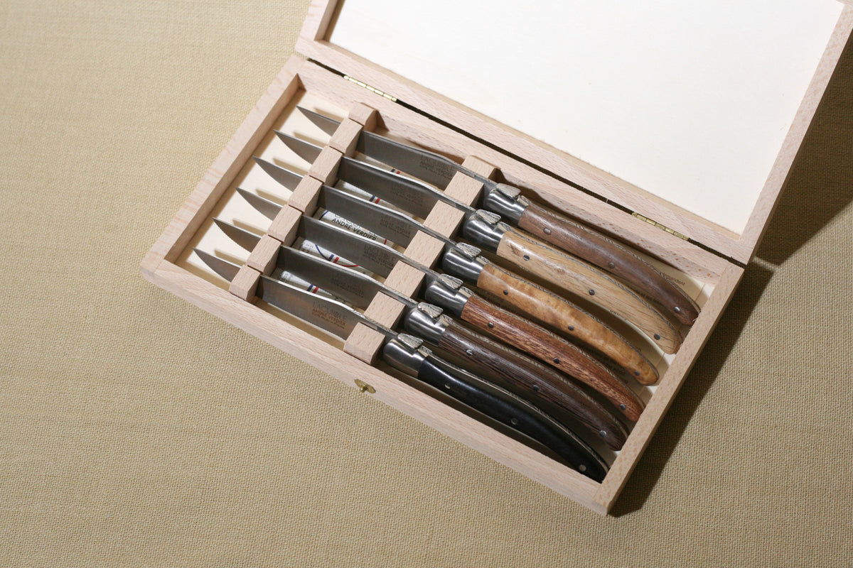 Laguiole Deluxe with mixed wood handles in box on a neutral background