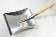 A German-style stainless steel dustpan with oiled beechwood handle from Burstenhaus Redecker.