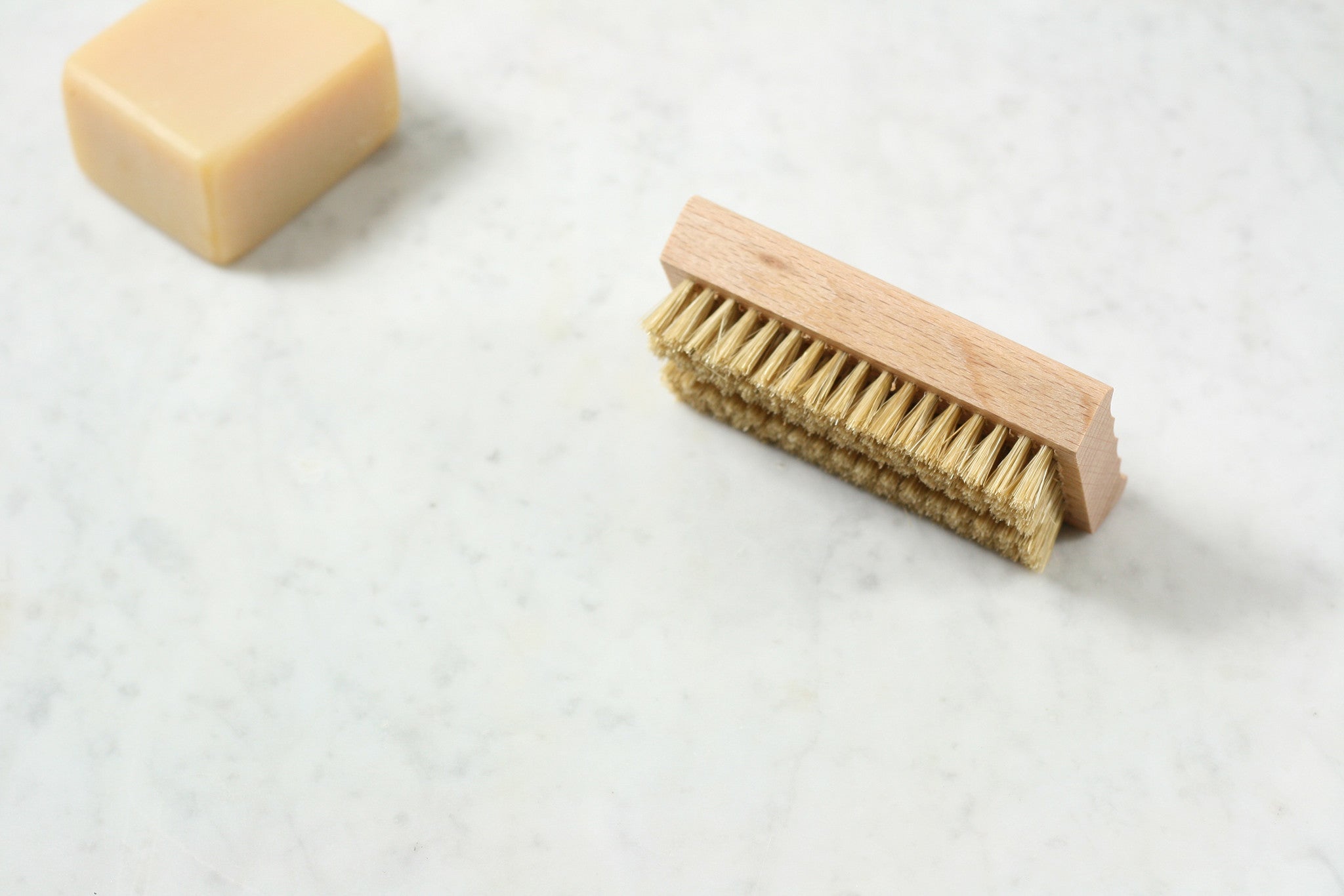 An oiled beechwood soap dish, with ridged surface, that does double duty as a nail brush. From Burstenhaus Redecker.